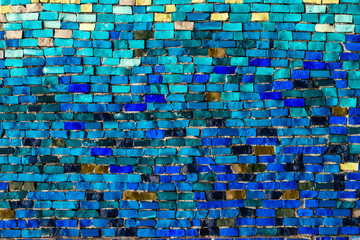 texture of multi-colored stones. Background from vintage mosaic on the wall.