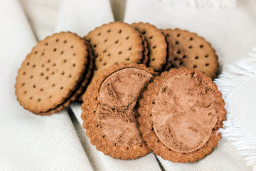 Crispy chocolate chip cookie with holes on the table. Filled Round Cookies