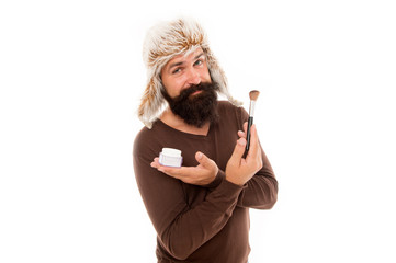 Professional cosmetics. Applying makeup face tone. Powder cosmetics. Man bearded stylist wear hat...