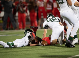 Action photos of high school football players making amazing plays during a football game