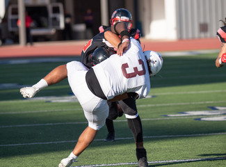 Fototapeta premium Action photos of high school football players making amazing plays during a football game