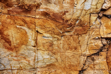 Stone wall granite natural surface texture. Structural surface close-up.