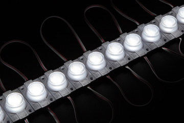 Single cold white led module on black background.
