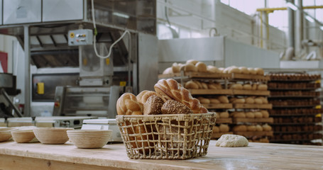 Details closeup vintage basket with organic bread on the tablet in a commercial bakery industry