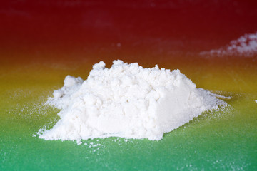 Flour with macro lens photographed against colorful gradient in studio