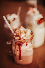 Close up shot of caramel milkshakes with marshmallows. Concept of restaurant, drinks and hospitality..