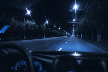 view from inside the car driving at night in the city traffic highway