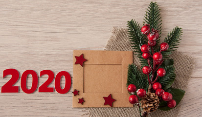 Christmas greeting card or photo frame over wooden table. View from above