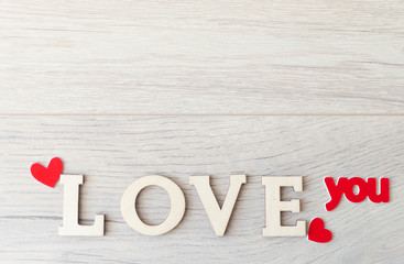 word Love from wooden letters on a wood background