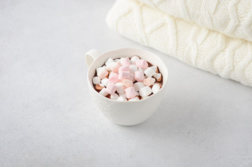 Cup of hot chocolate with marshmallows on a gray concrete background. Christmas concept.