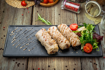 Homemade hot dog wraps in pita on black background