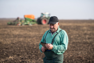 Farmer with tablet in field