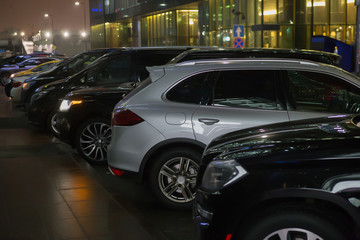 Cars in a parking lot at night in the city center