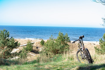 Fototapeta premium bicycle standing on dunes by the sea shore with view to the Baltic sea