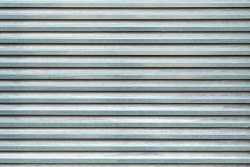 The texture of the ribbed metal sheet. Corrugated metal background.