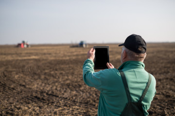 Farmer with tablet in field