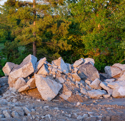 Concrete slab chunks near woods in golden hour