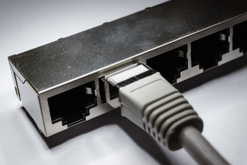 Isolated close up of through hole assembly rj45 cat5e ethernet networking hardware connector in...