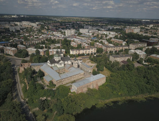 Berdychiv, Ukraine - 7 7 2019: Roman Catholic Church of the Assumption of the Blessed Virgin Mary. Aerial photography of the monastery with defense walls. Baroque architecture in a modern city