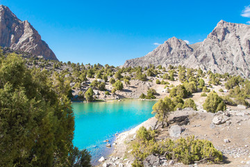 Summer mountains. Scenic landscape of mountain valley with blue lake in Fann mountains, Tajikistan. Amazing view on Kulikalon lake with turquoise water on clear bright day