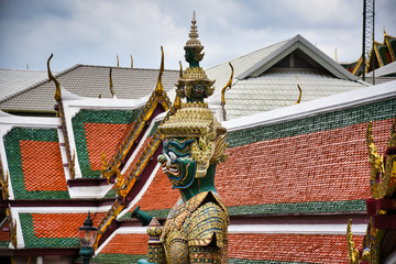 Fototapeta na wymiar Giant Yak, Yaksha statue with large teeth, piercing eye with sword in hand protecting and guarding the famous Temple of the Emerald Buddha or Wat Phra Kaew from evil spirits