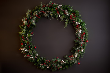 Christmas wreath red green on dark background