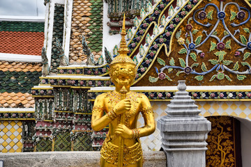 Beautifully stunning gold statue of a Kinnara, a beloved mythical half-human, half-bird creature on the Upper Terrace of Wat Phra Kaew or Temple of the Emerald Buddha in the Grand Palace in Bangkok