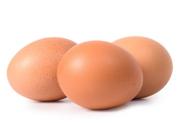 Three brown eggs isolated on white background