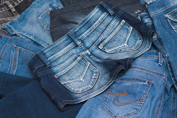 High Angle View of Rear Pockets of Three Different Styles of Blue Jeans in Various Color Washes