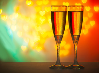 two glasses of champagne on a red background