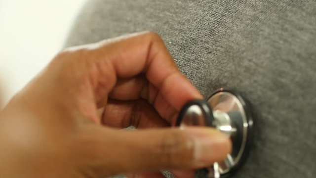 Doctor listens to a patient's lungs