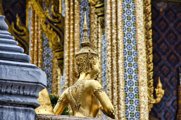 Beautifully stunning gold statue of a Kinnara, a beloved mythical half-human, half-bird creature on the Upper Terrace of Wat Phra Kaew or Temple of the Emerald Buddha in the Grand Palace in Bangkok