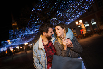 Young couple outside with shopping bags