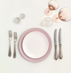 New luxury white and pink ceramic plate, silver vintage cutlery view from above on a isolated...