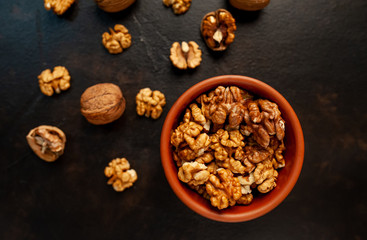 Walnuts. Kernels and whole nuts on a stone background