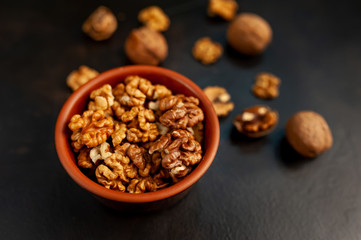 Walnuts. Kernels and whole nuts on a stone background