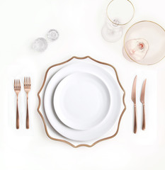 New luxury white ceramic plate, copper cutlery view from above on a isolated background. Top view....