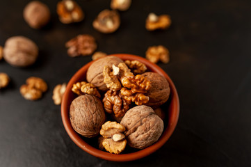 Walnuts. Kernels and whole nuts on a stone background