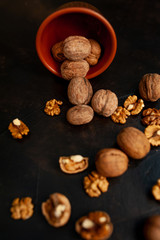 Walnuts. Kernels and whole nuts on a stone background