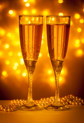 two glasses of champagne on red background