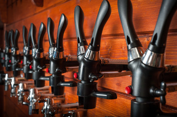Beer taps for draught drinks are built into wooden boards.