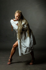 portrait woman with a creative hairstyle Afro-pigtails in the technique of Zizi. the girl in the straitjacket. The concept of mental disorder, trauma.