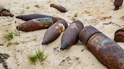 old rusty artillery shell and aircraft projectile in the desert