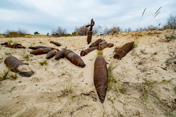old rusty artillery shell and aircraft projectile in the desert