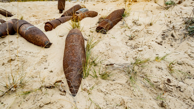 old rusty artillery shell and aircraft projectile in the desert