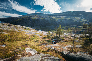 Fototapeta na wymiar Kinsarvik, Hordaland, Norway. Young Woman Lady Tourist Traveler Backpacker Hiking In Hardangervidda Mountain Plateau. Famous Popular Destination