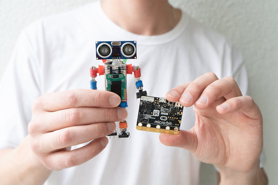 Minsk, Belarus. November, 2019. Teenager boy hold the BBC robot Micro Bit. He like it. It can be programming on Scratch and Python. Creative. Connected. Coding. Learning, teaching easy and fun. 