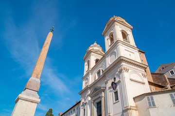 Santissima Trinita dei Monti church and Ancient Egyptian obelisk at the top of the Spanish steps in Rome.