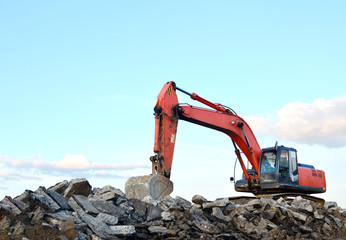 Large tracked excavator digs the ground for the foundation and construction of a new building in...