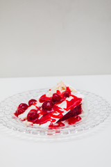 Obraz na płótnie Canvas Piece of cherry cake on a glass plate
